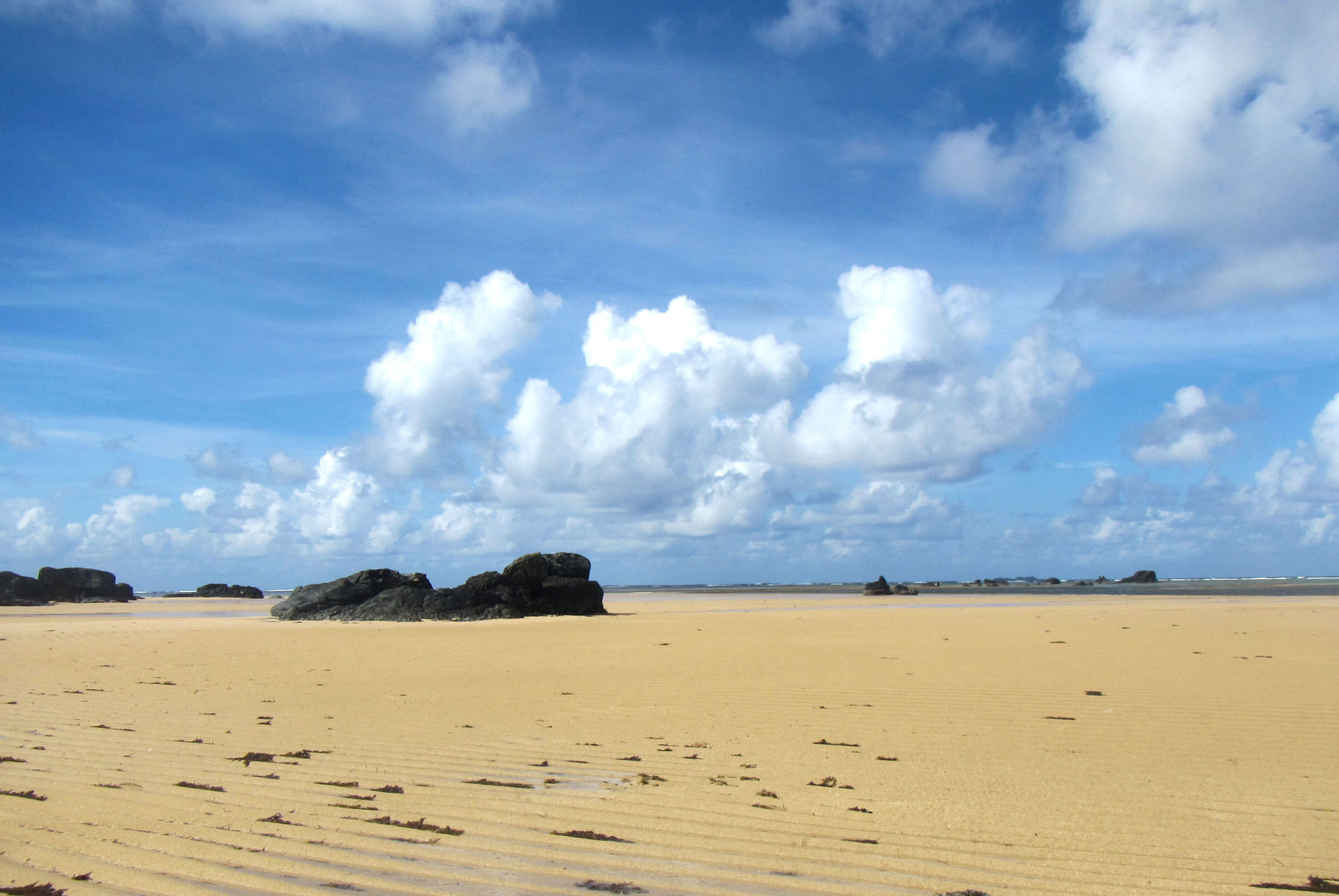 Low-tide golden sand at Kanaway Beach on Jomalig Island